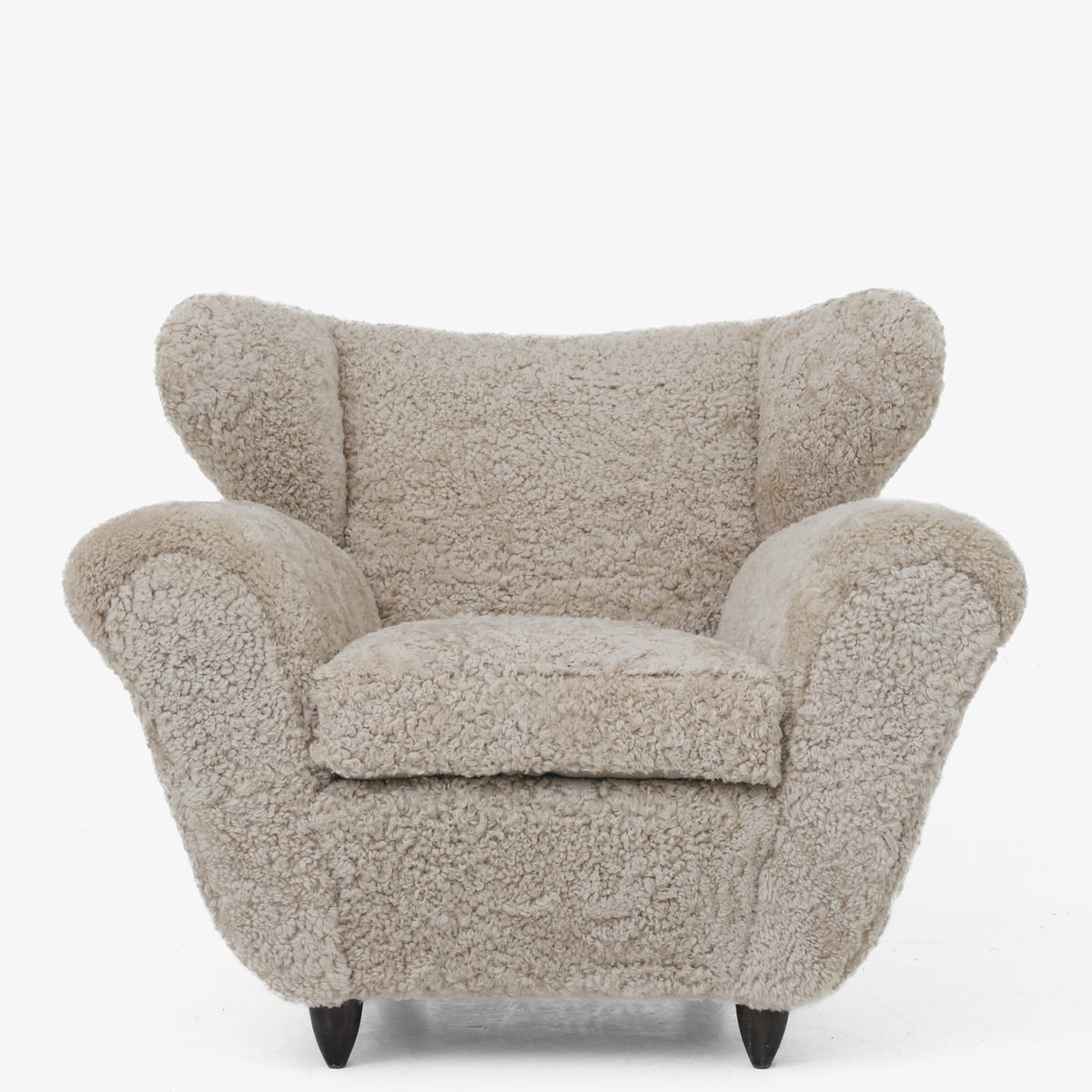 A pair of upholstered easy chairs in lambswool