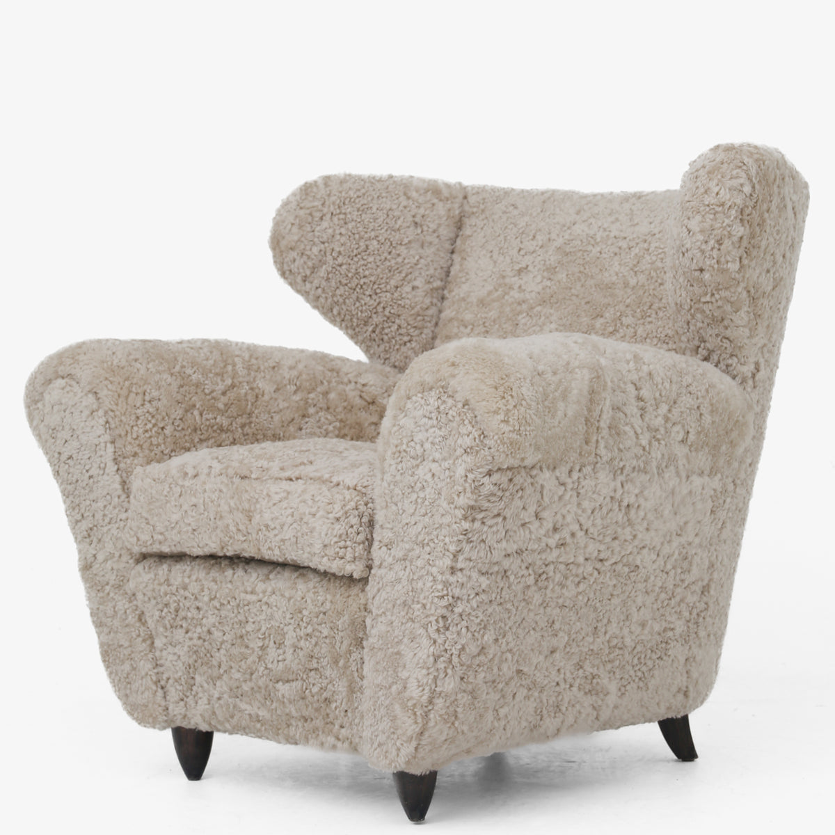 A pair of upholstered easy chairs in lambswool