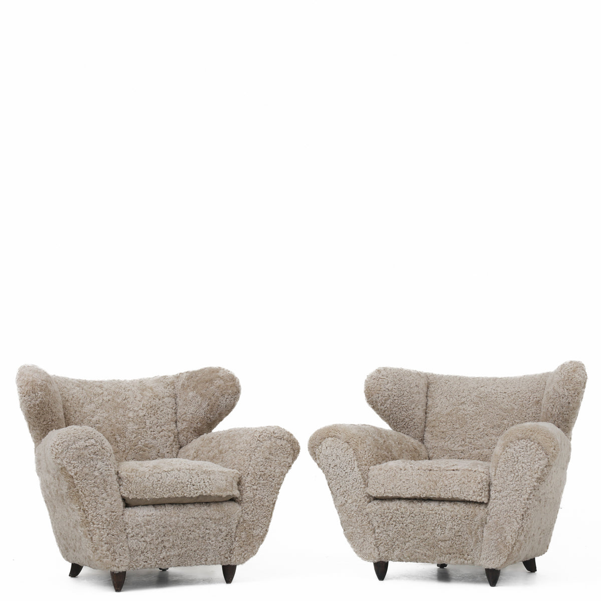 A pair of upholstered easy chairs in lambswool